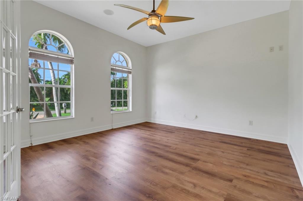 15480 River By Road Fort Myers, FL 33908 - Photo 19 of 48 Spare room with ceiling fan, dark wood-type flooring, vaulted ceiling, and french doors