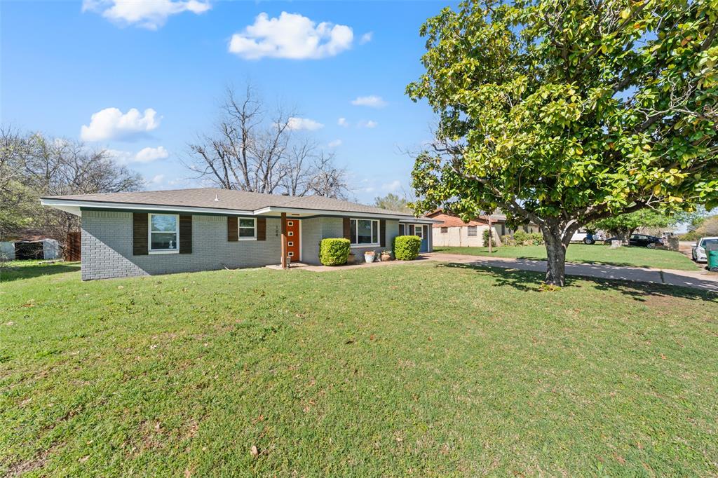 104 East Santa Anna Street Robinson, TX 76706 - Photo 4 of 36 a front view of a house with a garden