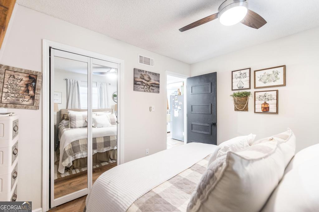 872 Henderson Road Dublin, GA 31021 - Photo 11 of 41 a bedroom with a bed and a chandelier