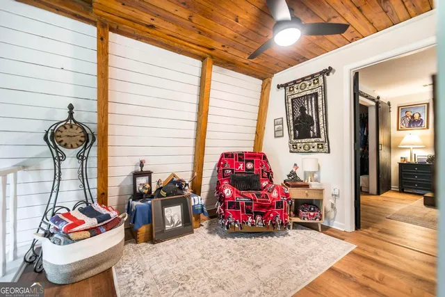 a bedroom with bed and wooden floor