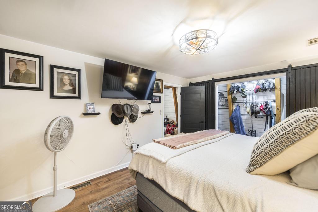 872 Henderson Road Dublin, GA 31021 - Photo 15 of 41 a bedroom with a bed a television and a large mirror on the dresser