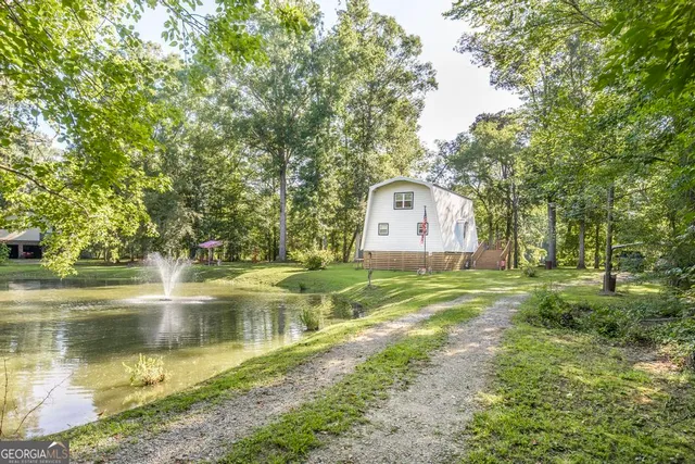 a swimming pool with outdoor seating and yard