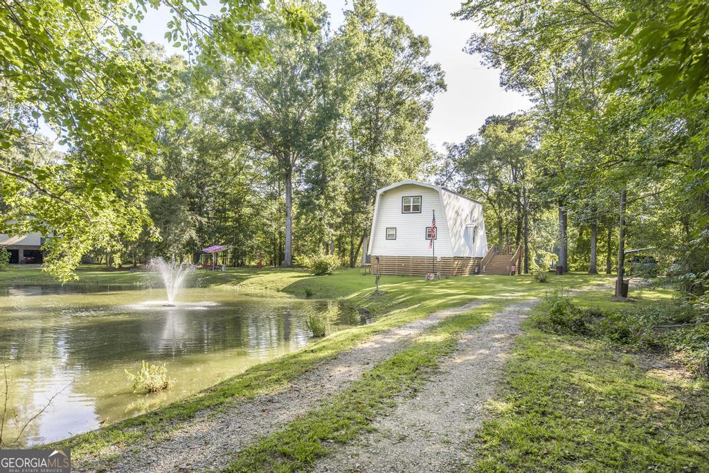 872 Henderson Road Dublin, GA 31021 - Photo 2 of 41 a swimming pool with outdoor seating and yard