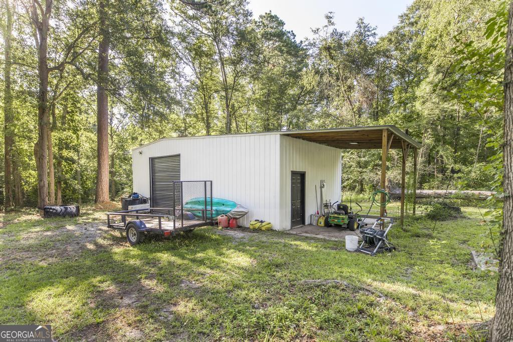 872 Henderson Road Dublin, GA 31021 - Photo 26 of 41 a view of a chair and table in backyard of the house