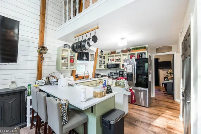 a open kitchen with stainless steel appliances kitchen island granite countertop a sink and cabinets