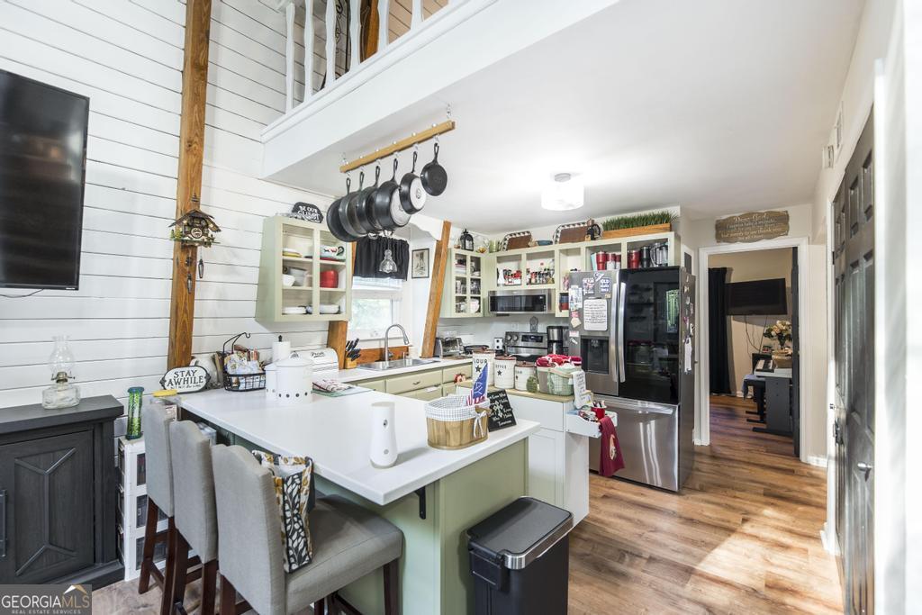 872 Henderson Road Dublin, GA 31021 - Photo 36 of 41 a kitchen with a sink a stove and a refrigerator