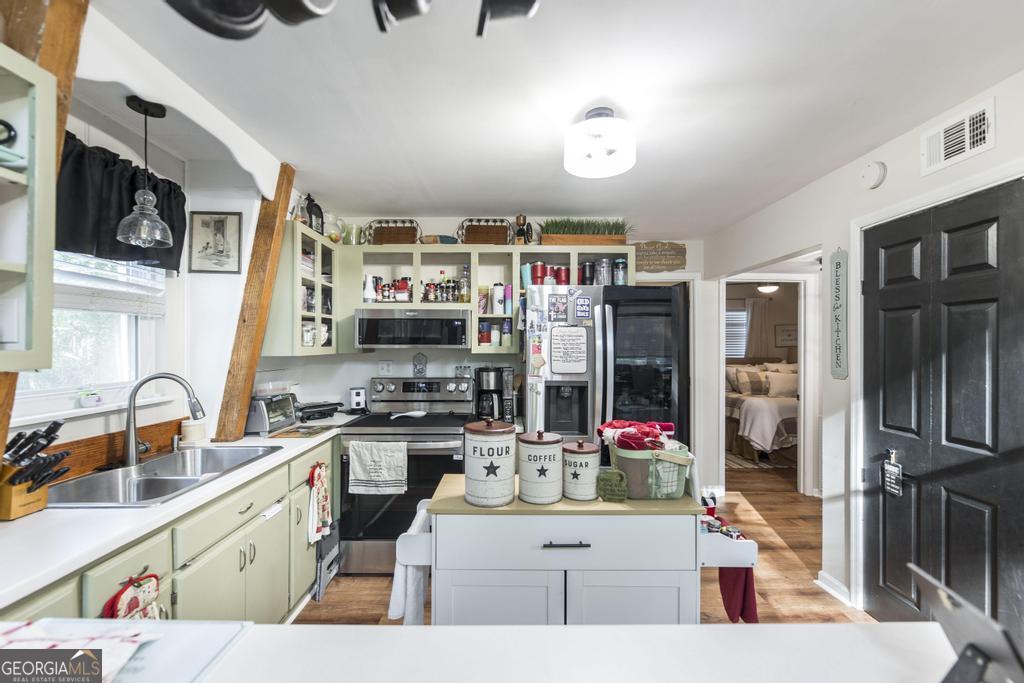872 Henderson Road Dublin, GA 31021 - Photo 37 of 41 a open kitchen with stainless steel appliances kitchen island granite countertop a sink and cabinets