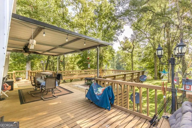 a view of a balcony with chairs and wooden floor