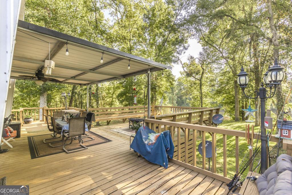 872 Henderson Road Dublin, GA 31021 - Photo 5 of 41 a view of a balcony with chairs and wooden floor