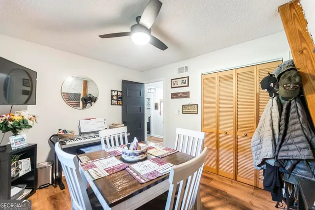 a bathroom with a sink vanity mirror bathtub and toilet