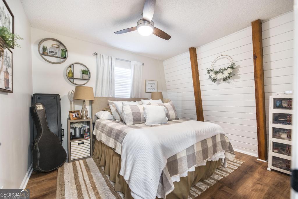 872 Henderson Road Dublin, GA 31021 - Photo 10 of 41 a bedroom with a bed and a chandelier