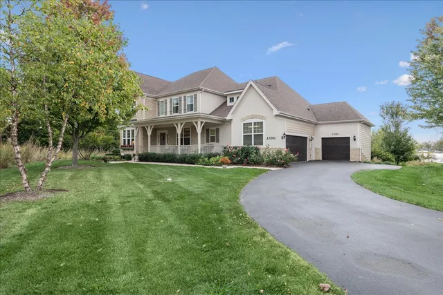 a front view of a house with a yard and potted plants
