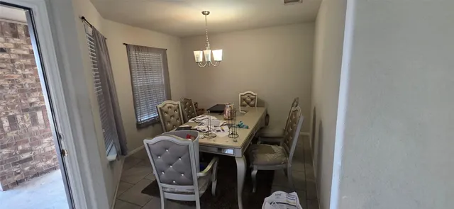 a view of a dining room with furniture and chandelier