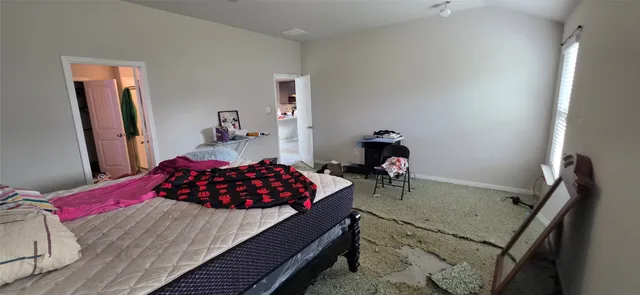 a bedroom with a bed and a dresser