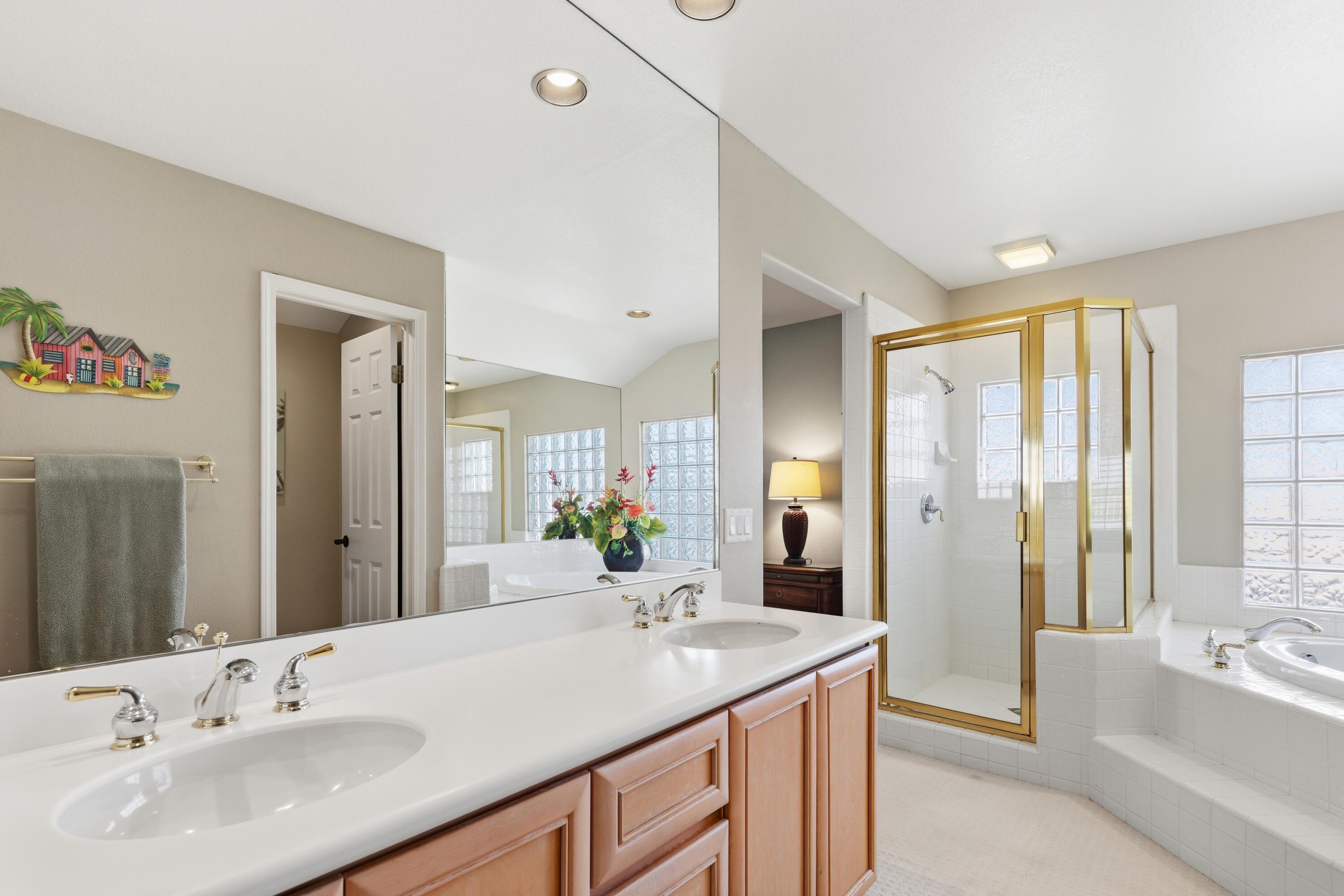 39 Augusta Drive Rancho Mirage, CA 92270 - Photo 38 of 53 a bathroom with a sink double vanity granite tub shower and a mirror