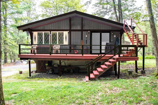 a backyard of a house with barbeque oven table and chairs