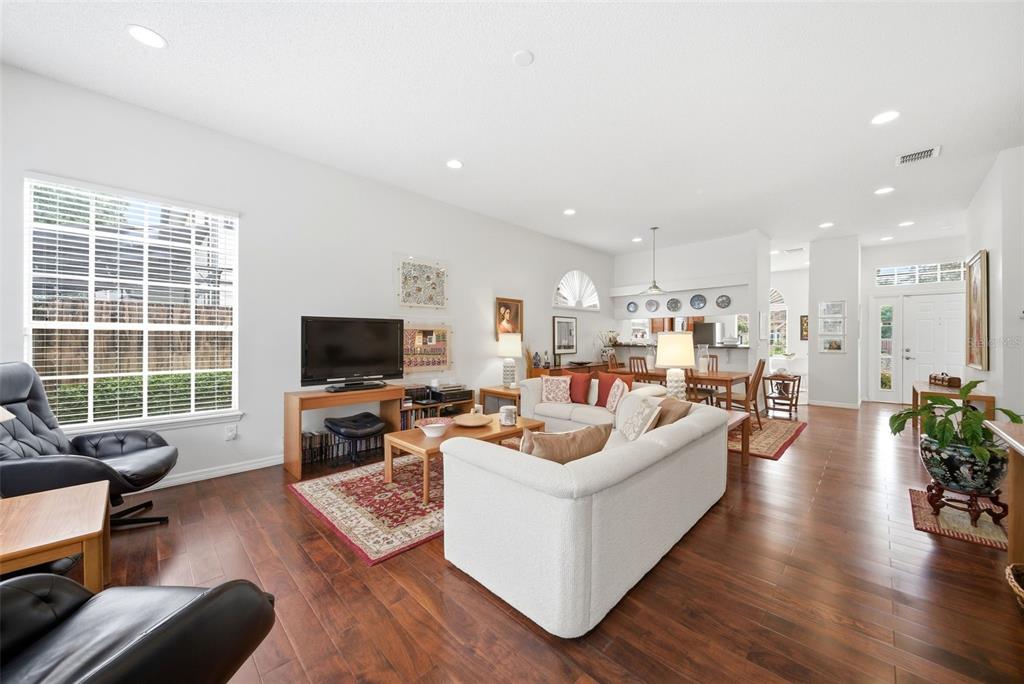 5452 Endicott Place Oviedo, FL 32765 - Photo 12 of 38 a living room with furniture flat screen tv and a large window