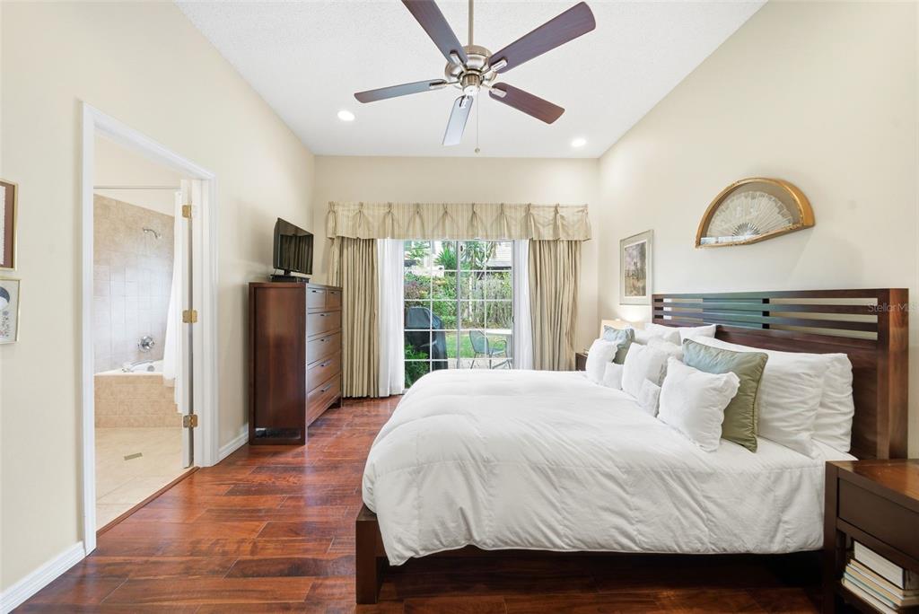 5452 Endicott Place Oviedo, FL 32765 - Photo 14 of 38 a bedroom with a large bed and a large window