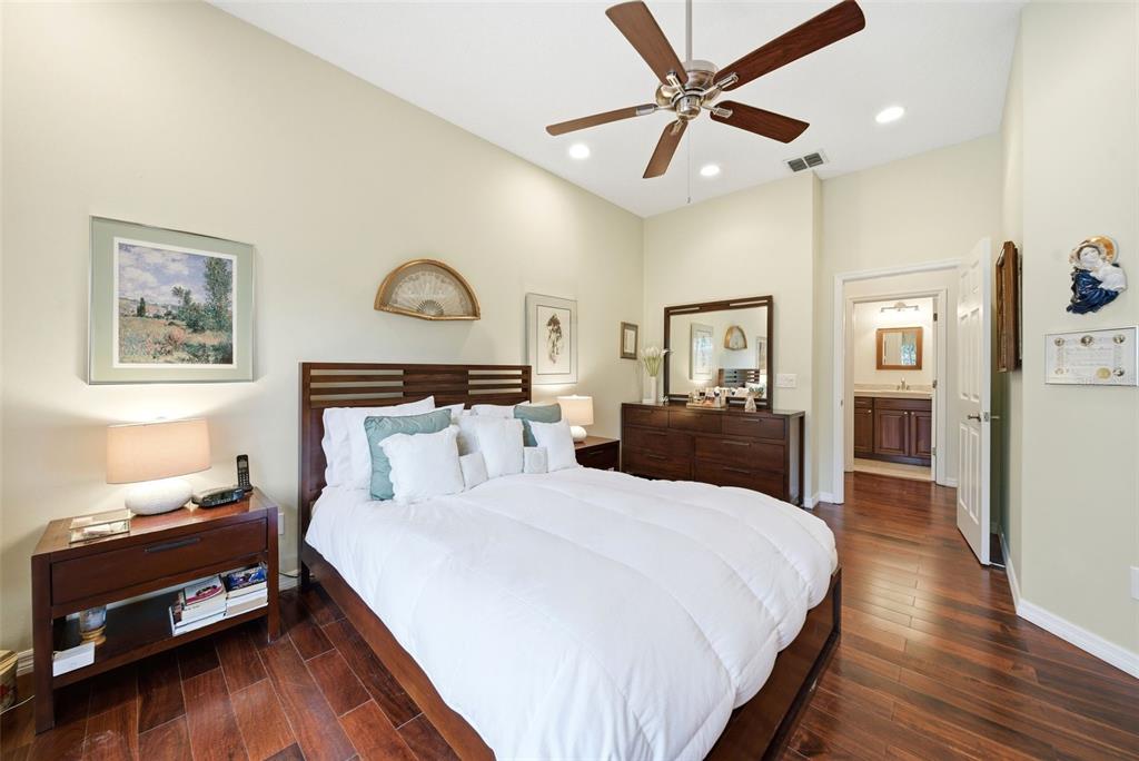 5452 Endicott Place Oviedo, FL 32765 - Photo 15 of 38 a bedroom with a bed and wooden floor