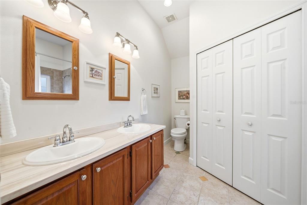 5452 Endicott Place Oviedo, FL 32765 - Photo 16 of 38 a bathroom with double vanity sinks and a mirror