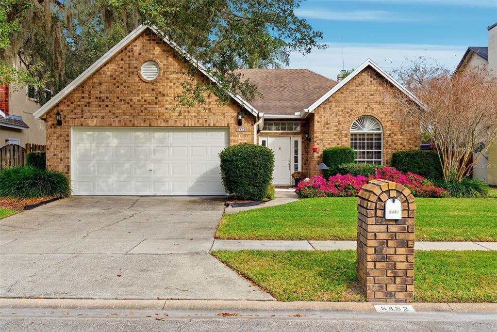 5452 Endicott Place Oviedo, FL 32765 - Photo 2 of 38 a front view of a house with a yard and garage