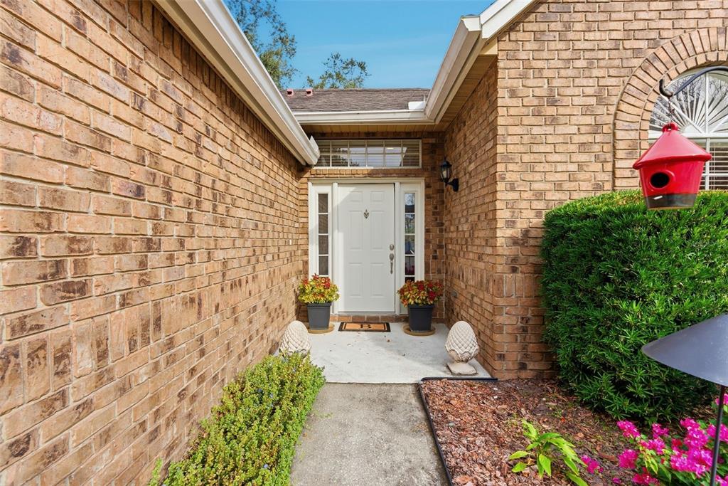 5452 Endicott Place Oviedo, FL 32765 - Photo 3 of 38 a front view of a house with a yard