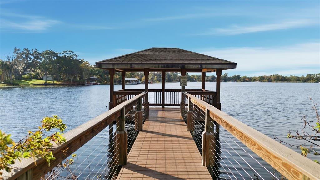 5452 Endicott Place Oviedo, FL 32765 - Photo 31 of 38 a view of a wooden deck and lake