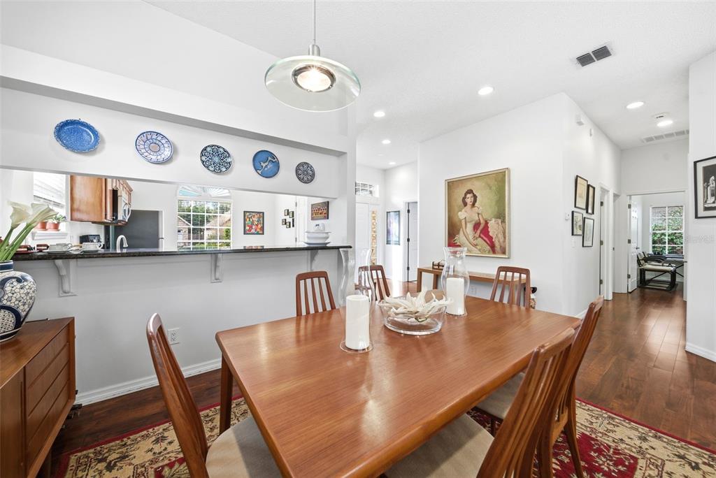 5452 Endicott Place Oviedo, FL 32765 - Photo 10 of 38 a view of a dining room with furniture and wooden floor