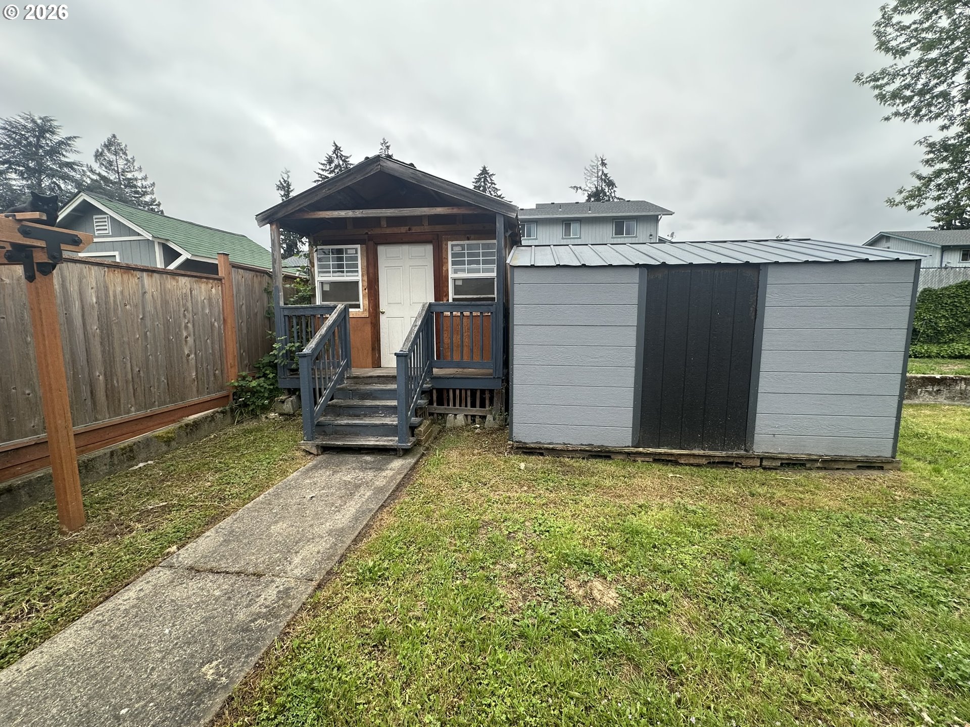 101 Southwest Peach Lane Winston, OR 97496 - Photo 17 of 22 a backyard of a house with table and chairs
