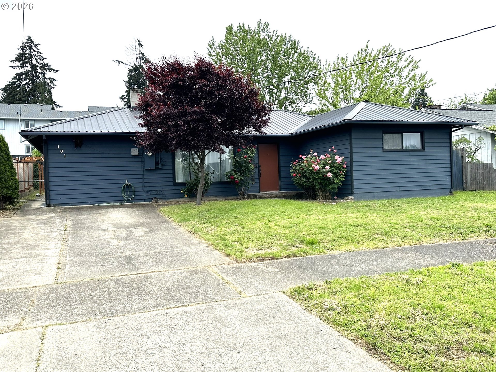 101 Southwest Peach Lane Winston, OR 97496 - Photo 2 of 22 a view of a house with a yard and garage