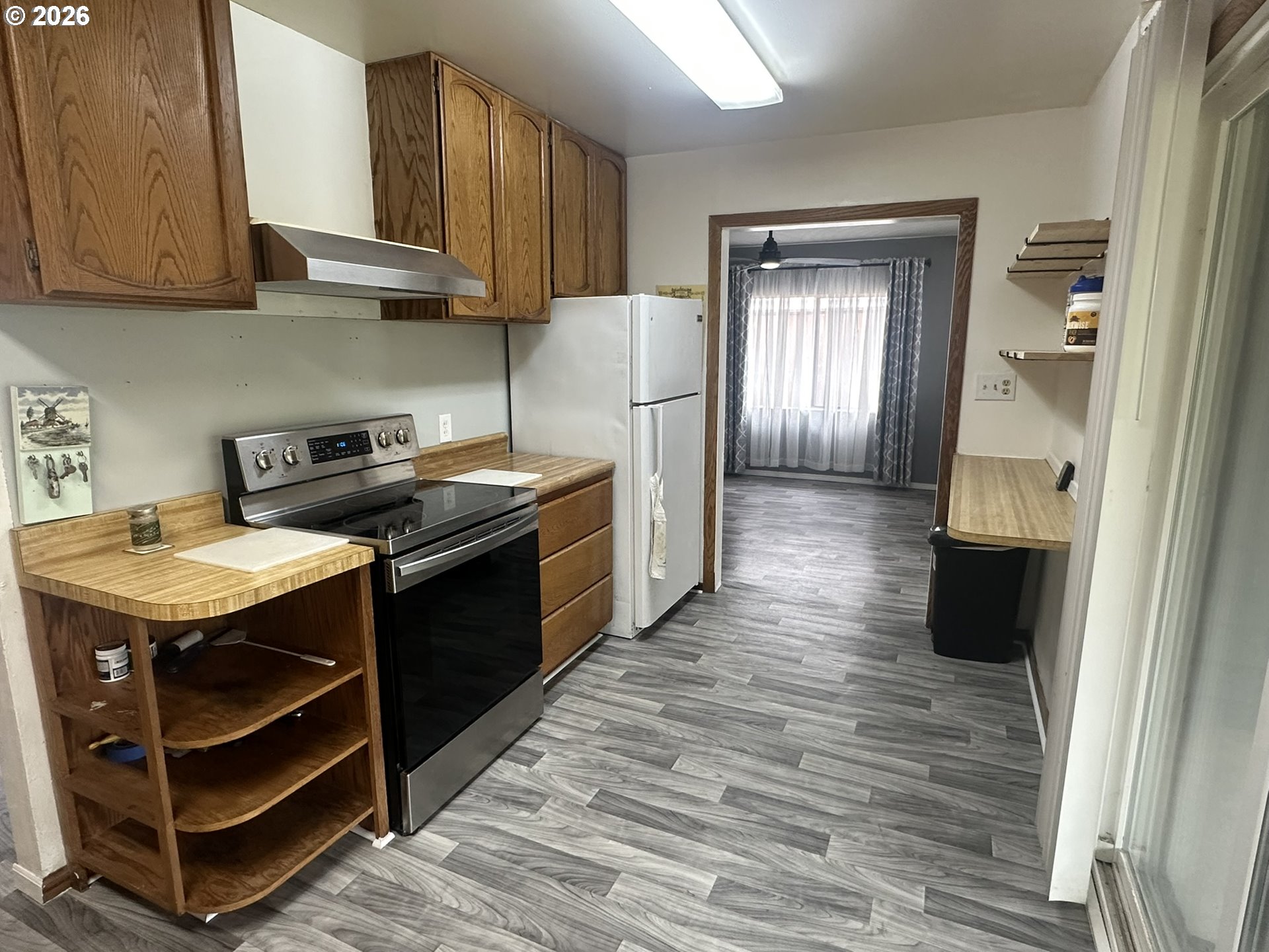 101 Southwest Peach Lane Winston, OR 97496 - Photo 6 of 22 a kitchen with stainless steel appliances granite countertop a stove and a refrigerator