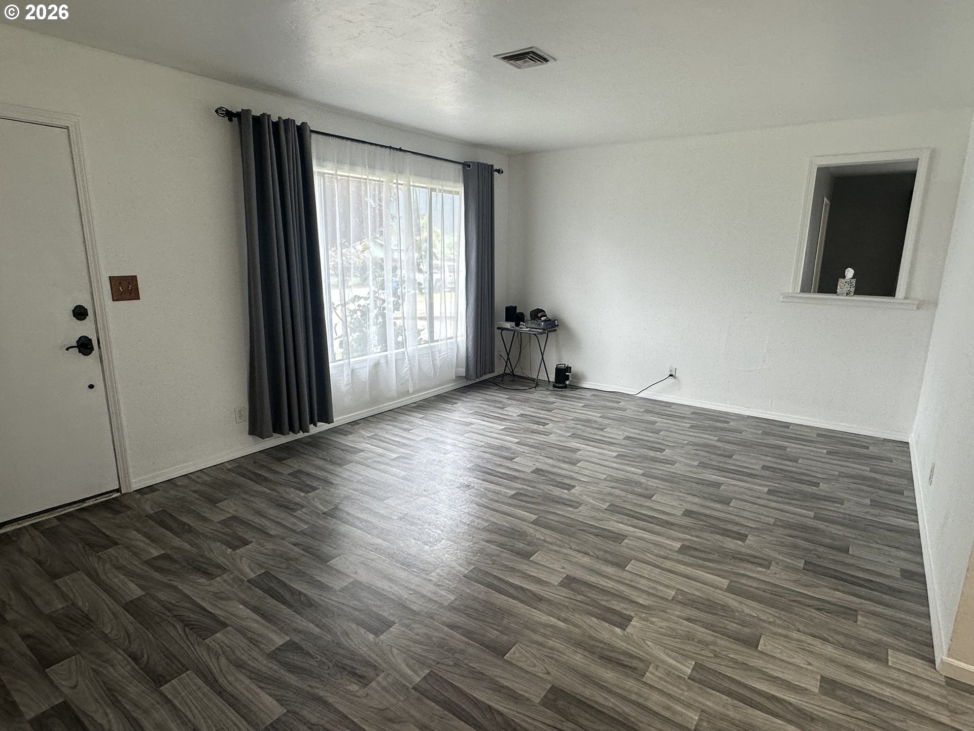 101 Southwest Peach Lane Winston, OR 97496 - Photo 9 of 22 wooden floor in an empty room with a window