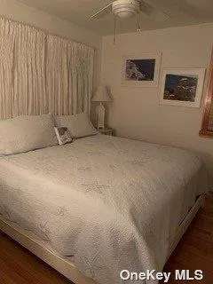 a spacious bedroom with a bed and a window