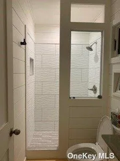 a bathroom with a double vanity sink a toilet and a mirror