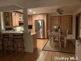 a dining room with furniture and flowers