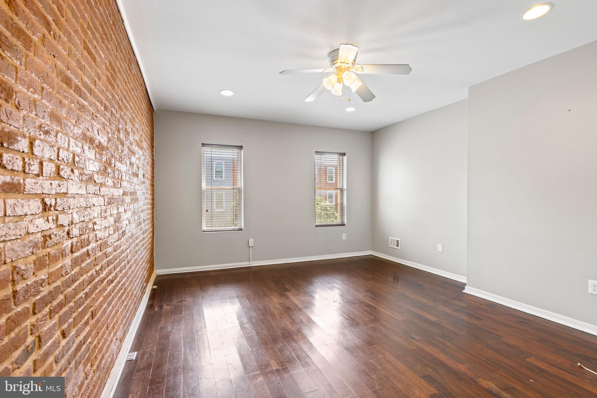 206 South Gilmor Street Baltimore, MD 21223 - Photo 14 of 27 a view of an empty room with wooden floor and a window