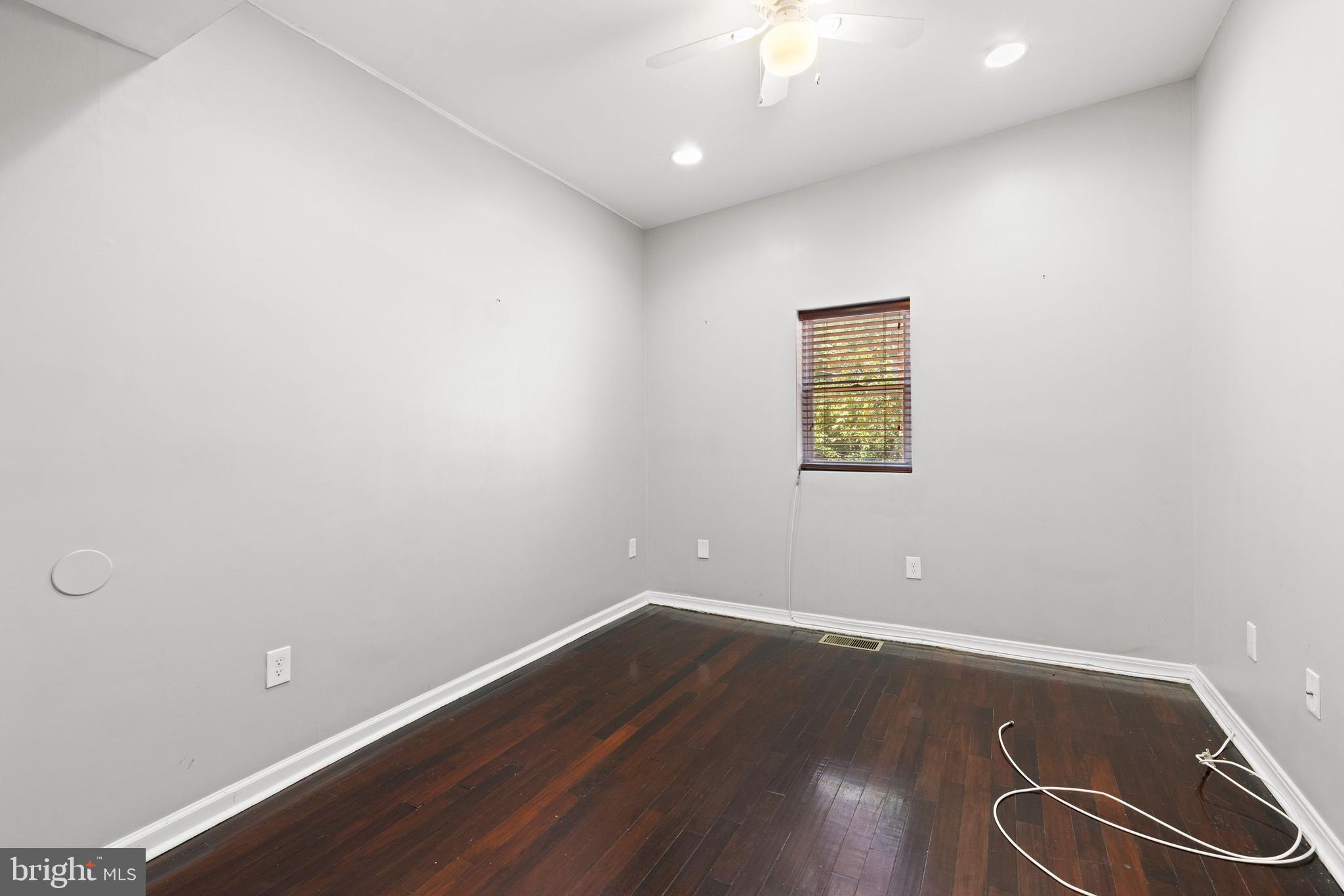 206 South Gilmor Street Baltimore, MD 21223 - Photo 16 of 27 an empty room with wooden floor and windows