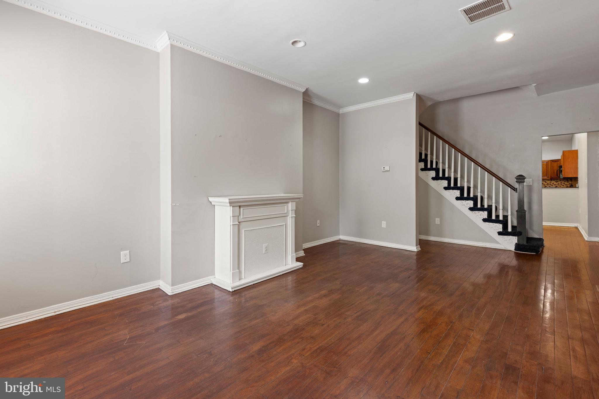 206 South Gilmor Street Baltimore, MD 21223 - Photo 2 of 27 a view of a hallway with wooden floor