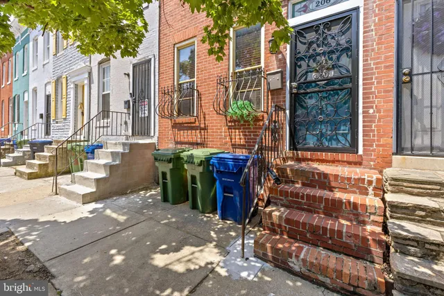 a view of a house with a backyard and sitting area