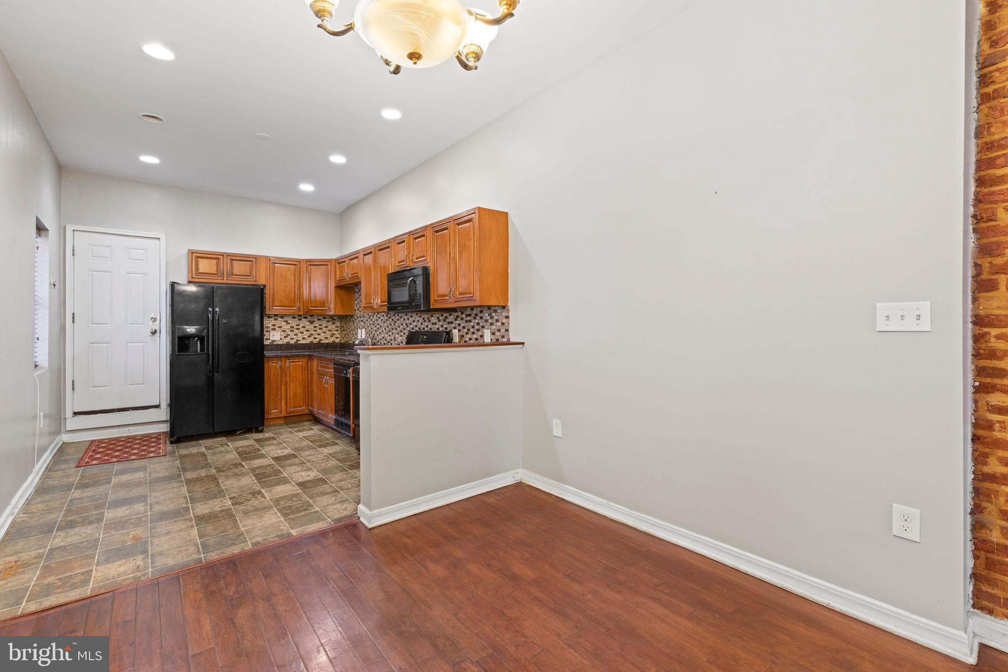 206 South Gilmor Street Baltimore, MD 21223 - Photo 7 of 27 a open kitchen with cabinets and stainless steel appliances