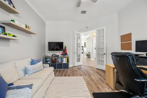 a spacious bedroom with a bed and wooden floor