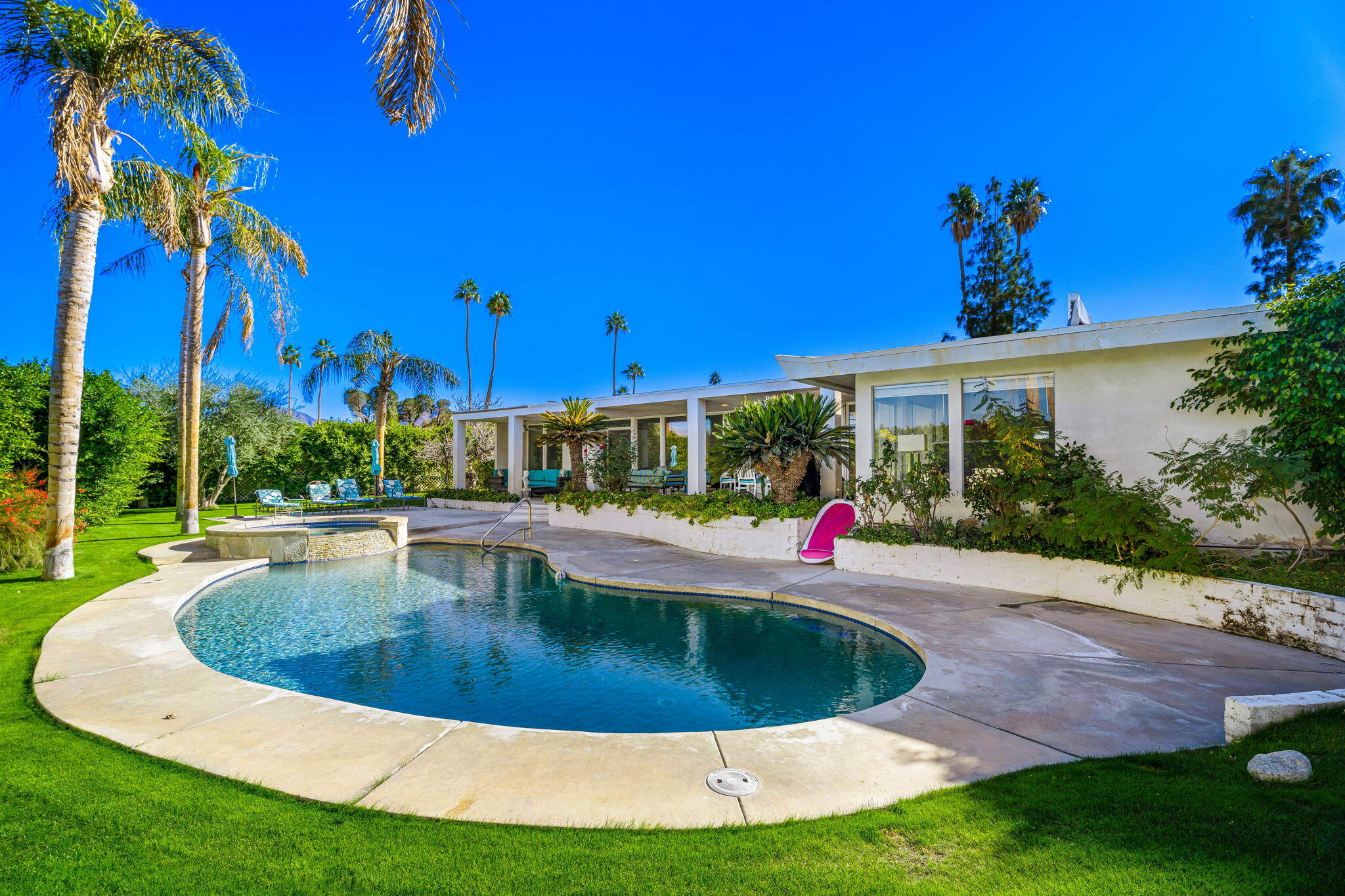 72890 Homestead Road Palm Desert, CA 92260 - Photo 26 of 45 a view of a swimming pool with a yard