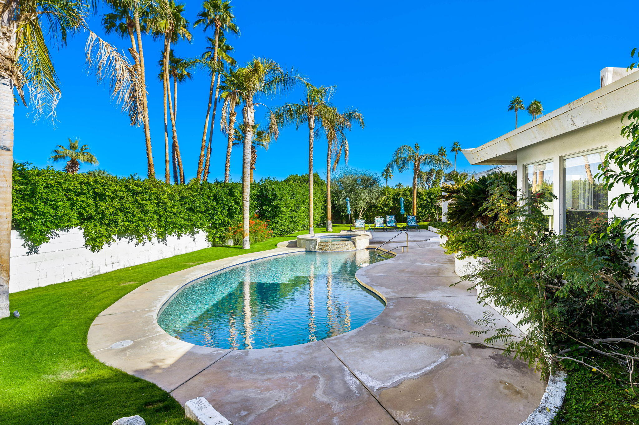 72890 Homestead Road Palm Desert, CA 92260 - Photo 27 of 45 a view of a swimming pool with a patio
