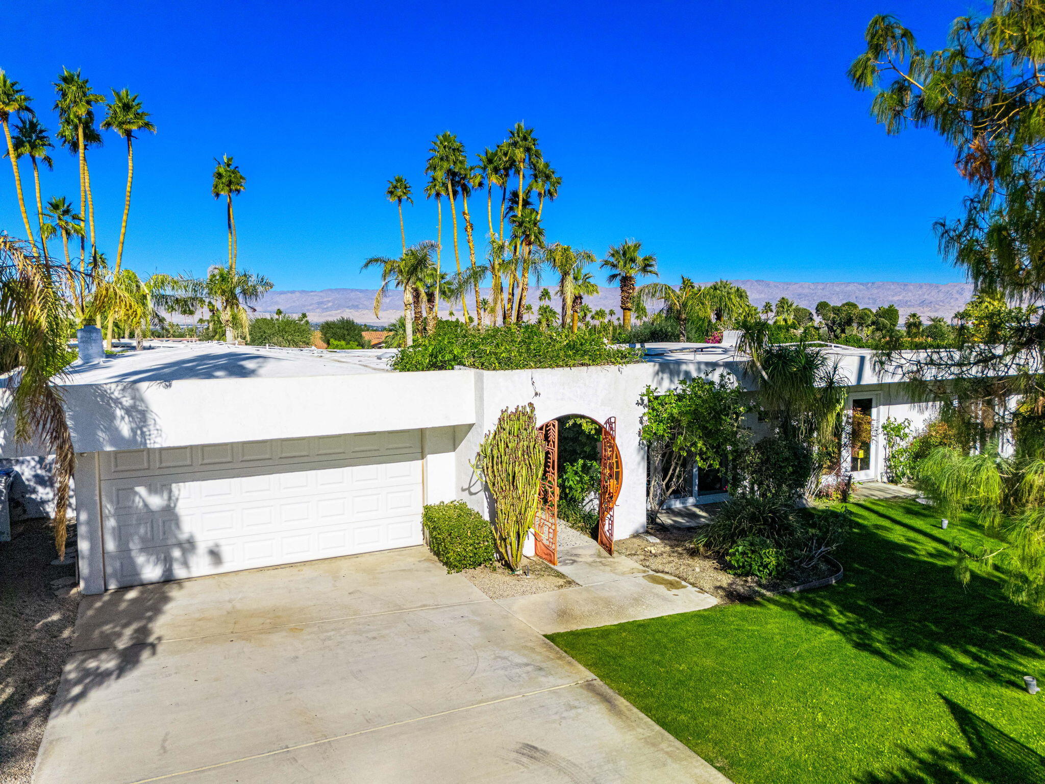 72890 Homestead Road Palm Desert, CA 92260 - Photo 6 of 45 a view of a lake with a floor to ceiling window next to a building and trees