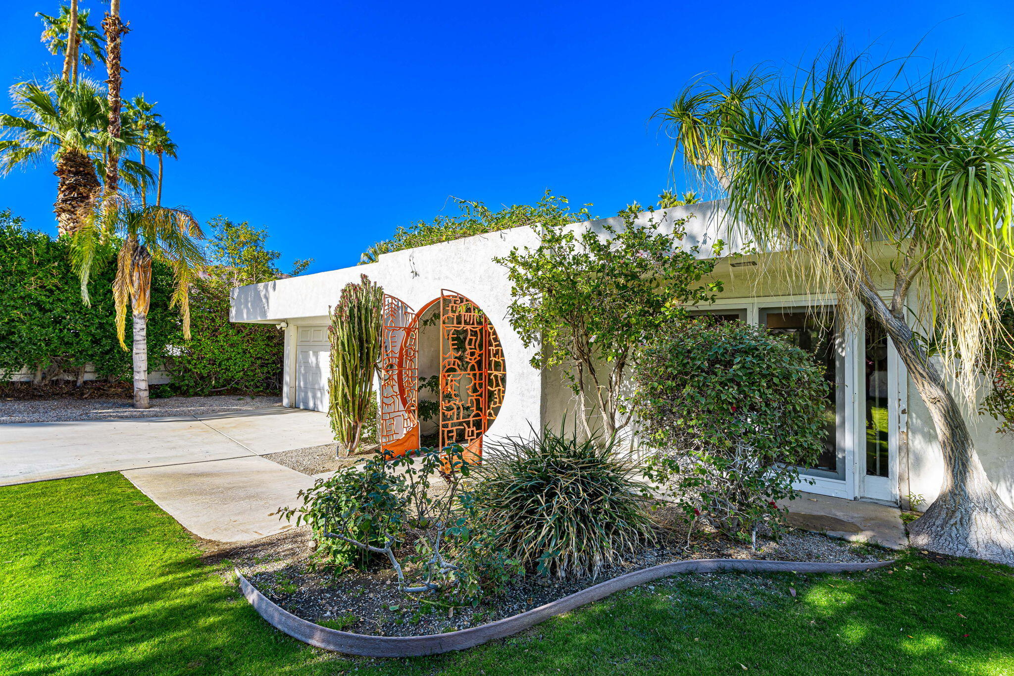 72890 Homestead Road Palm Desert, CA 92260 - Photo 9 of 45 a backyard of a house with plants and palm trees