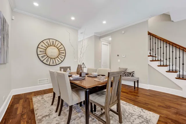 a dining room with furniture wooden floor and a rug