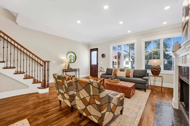 a living room with fireplace furniture and a wooden floor