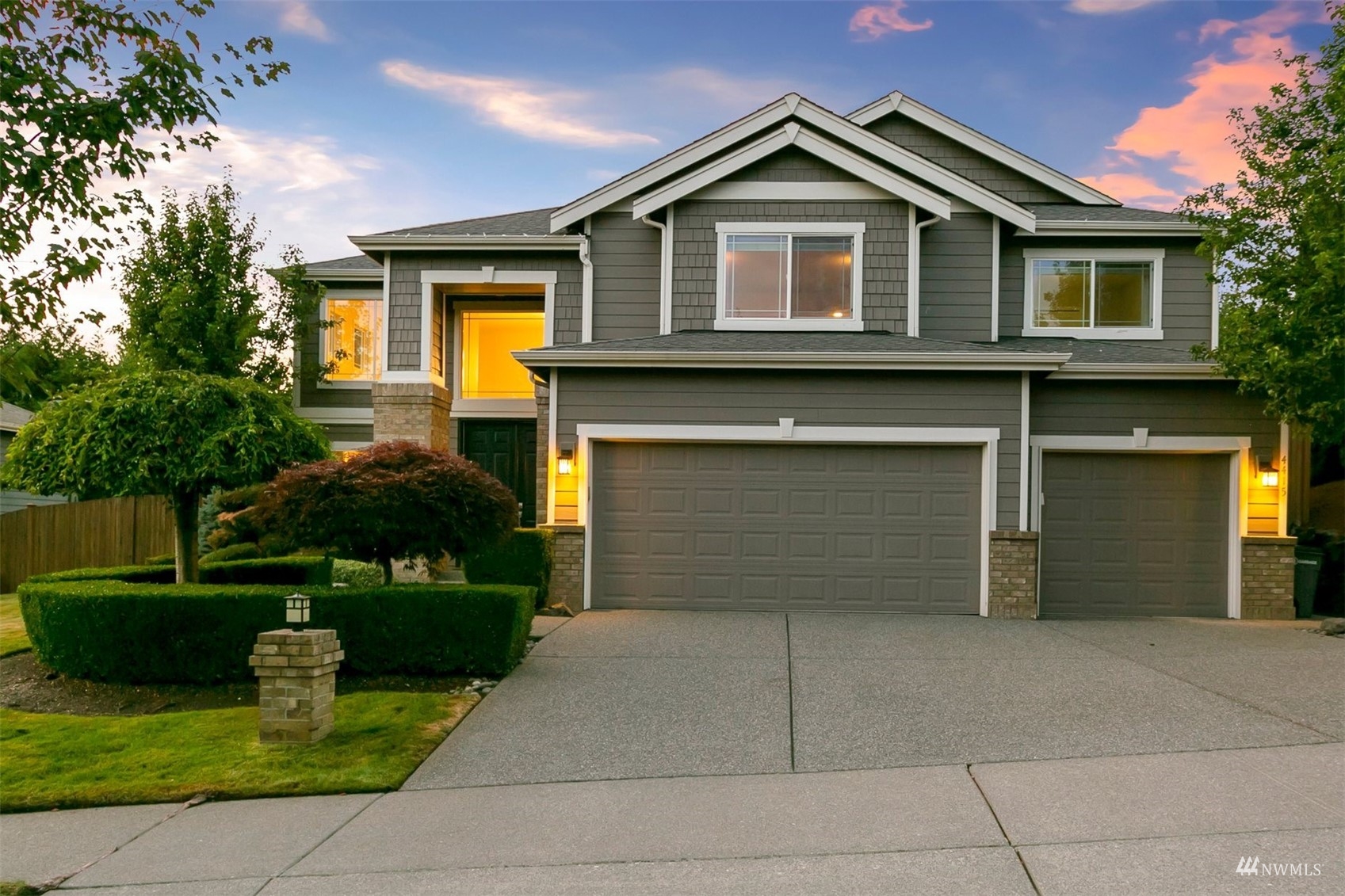 4415 240 Place Southeast Bothell, WA 98021 - Photo 1 of 40 a front view of a house with a yard and a garage