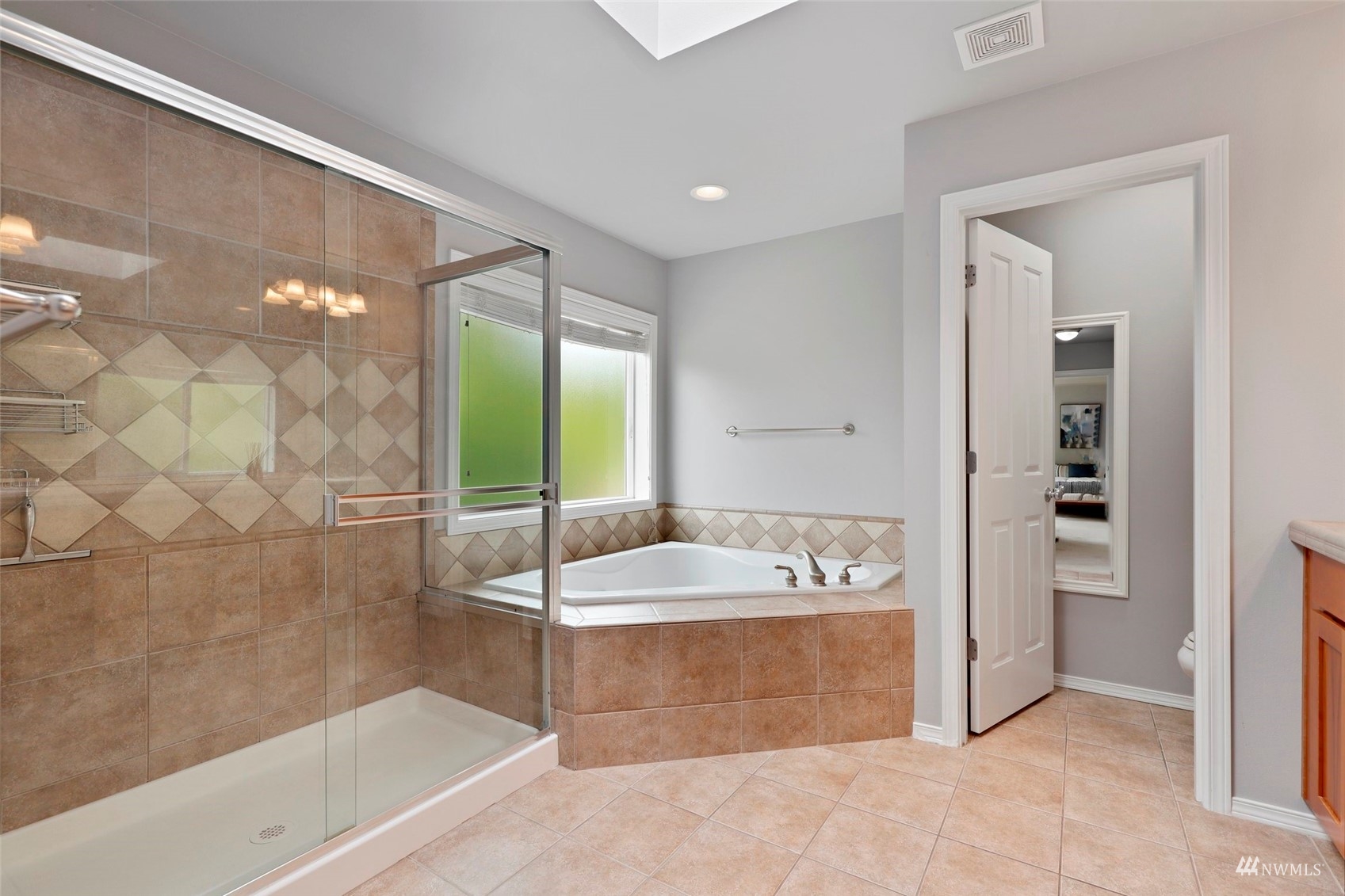 4415 240 Place Southeast Bothell, WA 98021 - Photo 27 of 40 a spacious bathroom with a tub shower and sink