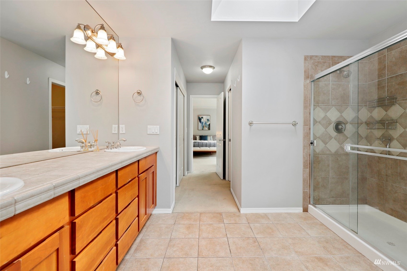 4415 240 Place Southeast Bothell, WA 98021 - Photo 28 of 40 a spacious bathroom with a granite countertop sink a shower and a mirror